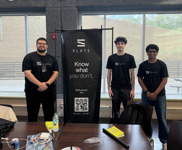 Daniel, Hatem, and Sanjeev standing with the Slate banner at a hackathon